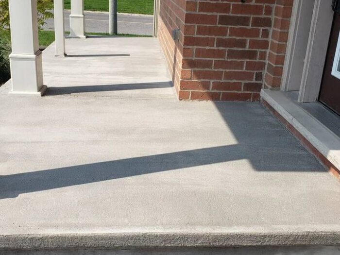 Concrete walkway resurfaced beside a house
