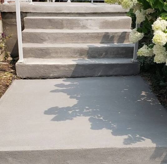 Resurfaced porch floor under a covered entrance