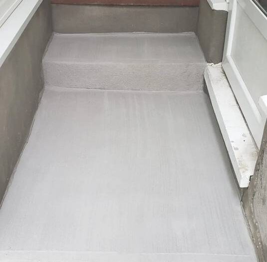 Spalled concrete covered with a new durable surface