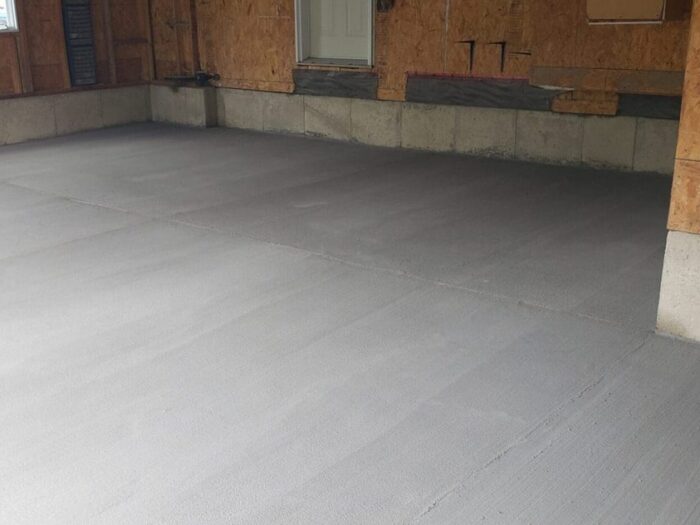 Resurfaced garage floor in a newly framed garage