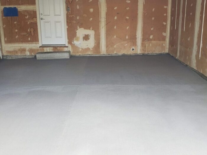 Resurfaced garage floor and interior threshold