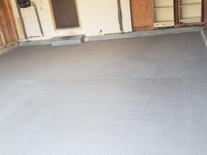 Resurfaced garage floor finished to the door line