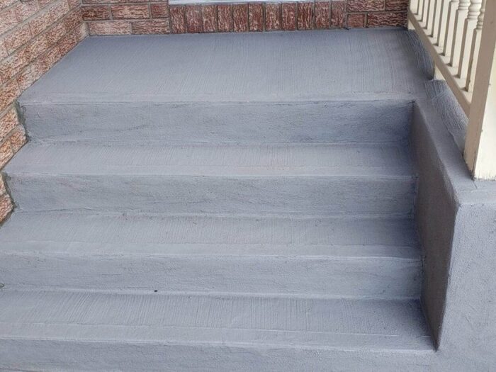 Resurfaced front steps at a brick entrance