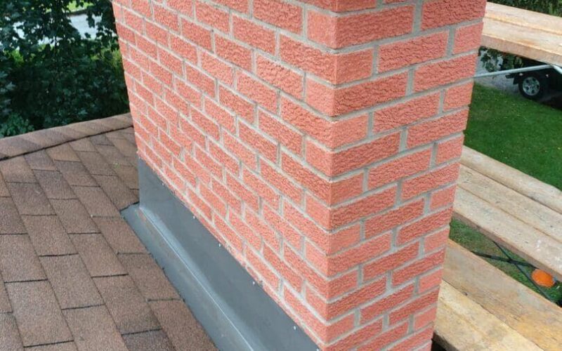 Rebuilt brick chimney with a new metal cap on an Ottawa home